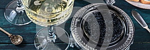 Champagne and caviar panorama. Vintage coupe glass and bowl