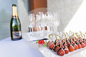 Champagne and chocolate covered strawberries served as an appetizer snack and welcome drink photo