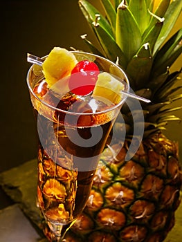 Champagne cocktail with cherry and pineapple .