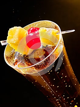 Champagne cocktail with cherry and pineapple