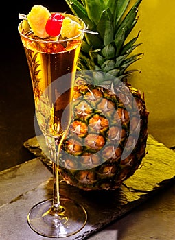 Champagne cocktail with cherry and pineapple