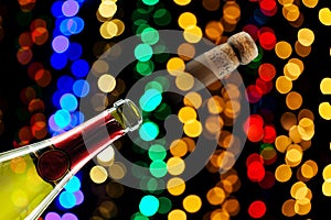 Champagne cork popping and on black colorful party celebration background