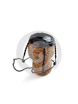 Champagne cork, with a wire muselet and a black metal lid