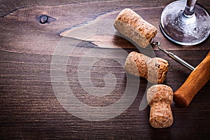 Champagne corks and corckscrew on vintage wooden