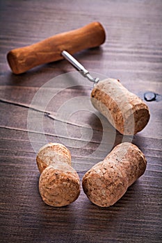 Champagne corks and corkscrew on vintage wooden