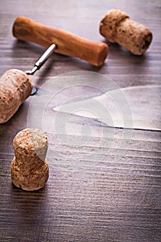 Champagne corks and corkscrew on vintage wooden