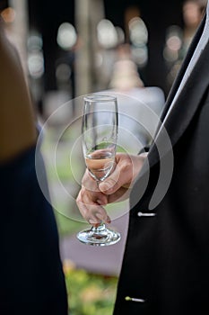 A champagne crystal glass in holding hand.