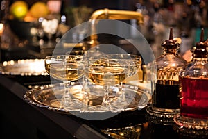 Champagne drinks in glasses on the bar counter.