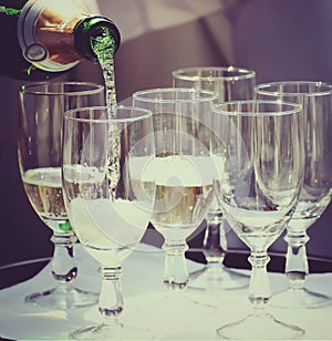 Champagne flows into the wineglasses