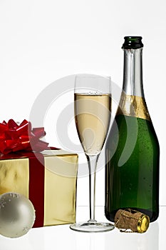 Champagne flute and bottle with christmas gift