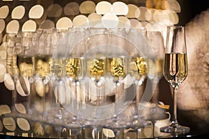 Champagne flutes on shiny, glassy background