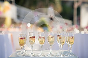 Champagne flutes with wine and strawberries await thristy guests
