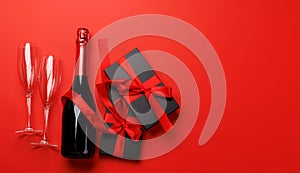 Champagne and gift: Celebratory duo on a red background with text space