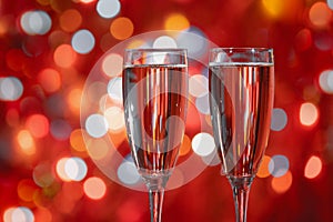 Champagne glass close up on Christmas and New Year holiday bokeh background