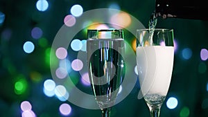 Champagne glass close up on Christmas and New Year holiday bokeh background