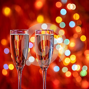 Champagne glass close up on Christmas and New Year holiday bokeh background