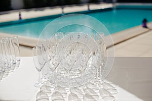 Champagne glass with dining set prepare dinner on table by the swimming pool