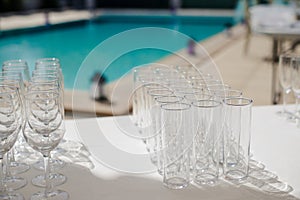 Champagne glass with dining set prepare dinner on table by the swimming pool