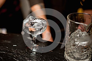 Champagne glass with ice and transparent drink