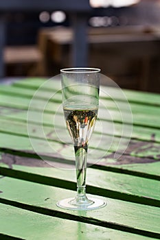 Champagne glass on painted wood table