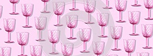 Champagne glass pattern on pink background with copy space for text. Top view. Holiday and celebration concept. Packing design.