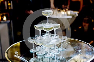 Champagne glass pyramid.pyramid of glasses of wine, champagne, tower of champagne`s glass in wedding reception party