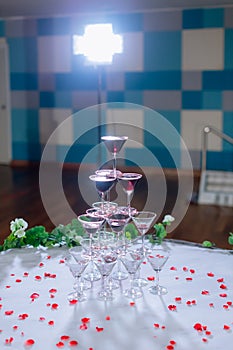 Champagne glass pyramid. Pyramid of glasses of wine, champagne, tower of champagne`s glass in wedding reception party