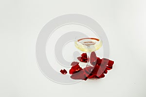 champagne glass with rose leaves abstract background