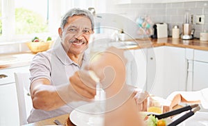 Champagne, glass and senior couple man for birthday celebration in Mexico home kitchen. Happy elderly people celebrate