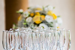 Champagne glasses against flower bouquet