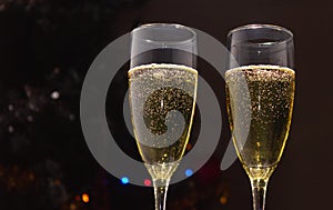 Champagne glasses on the background of a decorated Christmas tree. The concept of a holiday, New Year