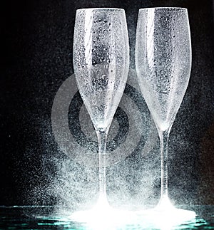 Champagne glasses on black spray