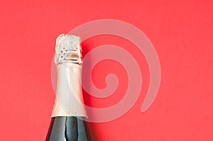 Champagne glasses and bottle on red background, space for text. Christmas decoration