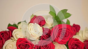 Champagne glasses and bouquet of red, white roses on white background