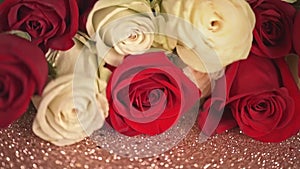 Champagne glasses and bouquet of red, white roses on white background