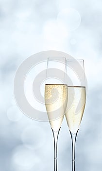 Champagne glasses on bright blue background