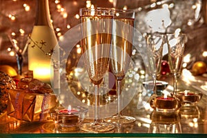 Champagne in glasses, candle,gift box and lights