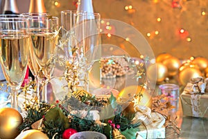 Champagne in glasses,candles,baubles and lights.