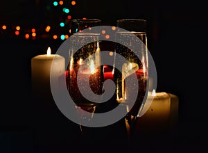 Champagne glasses and candles - romantic celebration on bokeh background