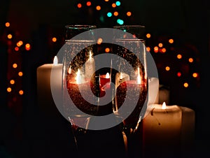 Champagne glasses and candles - romantic celebration on bokeh background