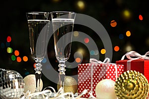 Champagne glasses and Christmas balls and Christmas gifts