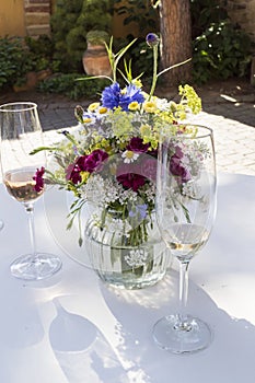 Champagne glasses festively arranged on a table with a bouquet of flowers