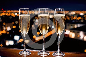 Champagne glasses flutes on balcony overlooking city, festive special occasion