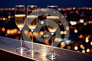 Champagne glasses flutes on balcony overlooking city, festive special occasion