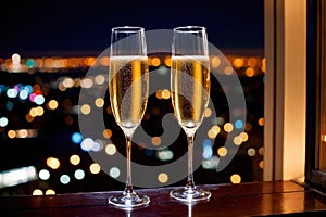 Champagne glasses flutes on balcony overlooking city, festive special occasion