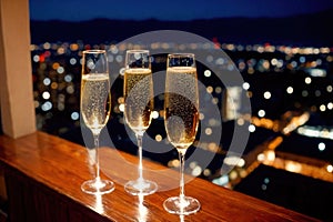 Champagne glasses flutes on balcony overlooking city, festive special occasion