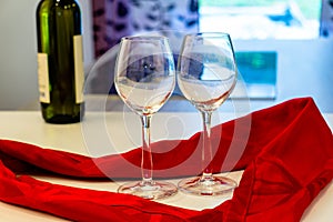 Champagne glasses with glass hearts wine bottle and red ribbon