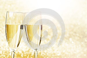 Champagne glasses on glitters background