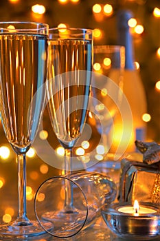 Champagne in glasses and lights on background.