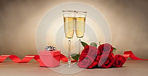 Champagne glasses, present and roses